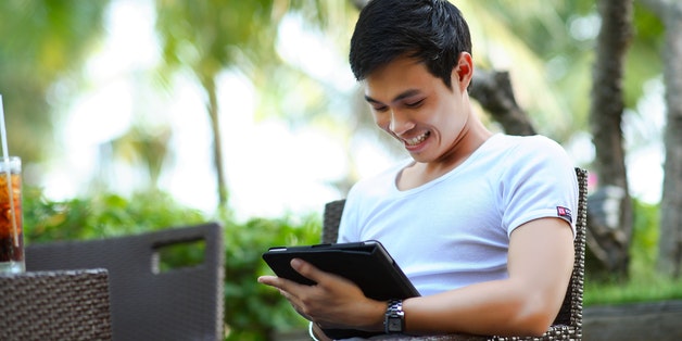 man-smiling-at-tablet